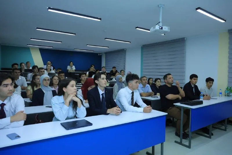 Cohort 3 students seated in the tiered classroom at Tashkent International University during the September 8 orientation, some in suits after the working day (Photo: TIU)